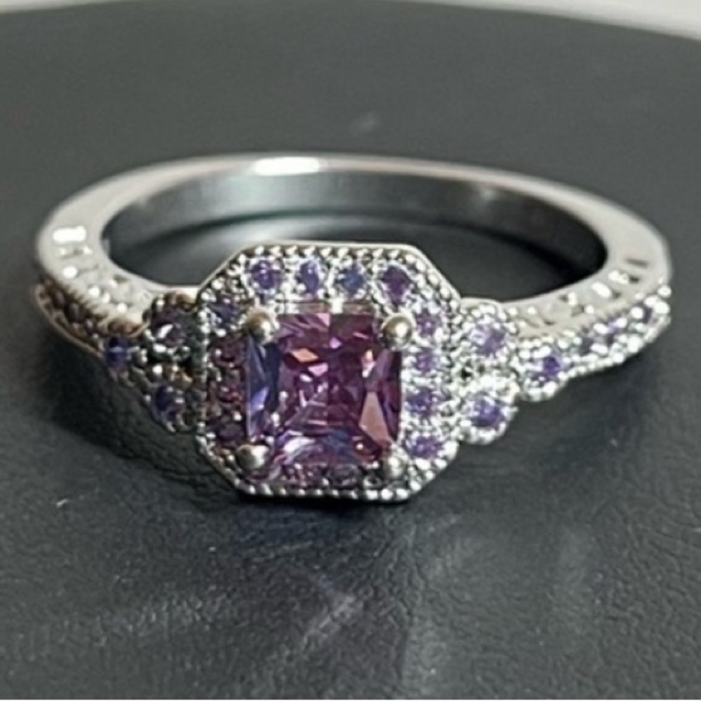 Silver tone ring with purple accents. Size 8